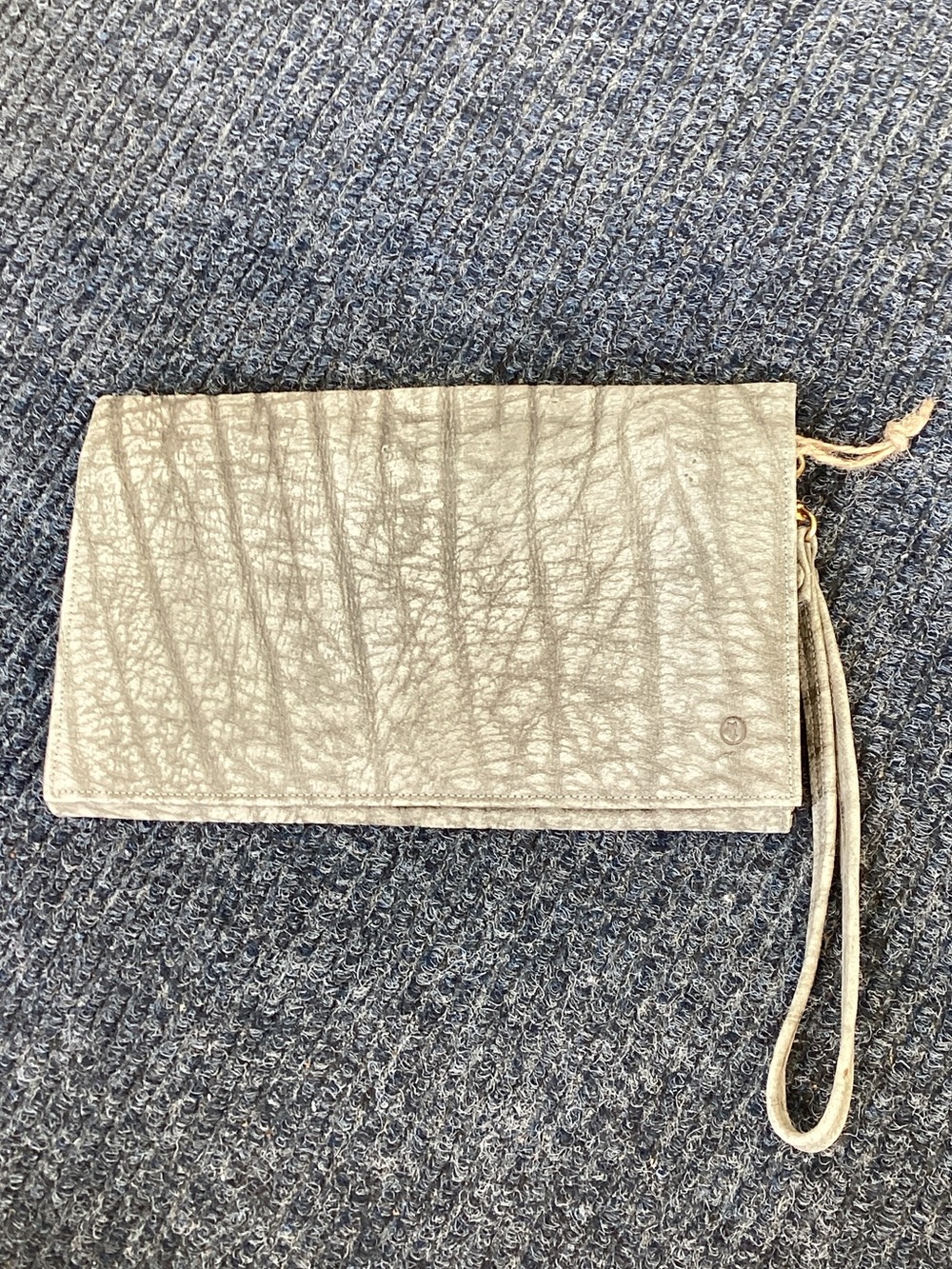 Vintage Yoder African buffalo hide wristlet. Detachable strap. 6x9x1”.